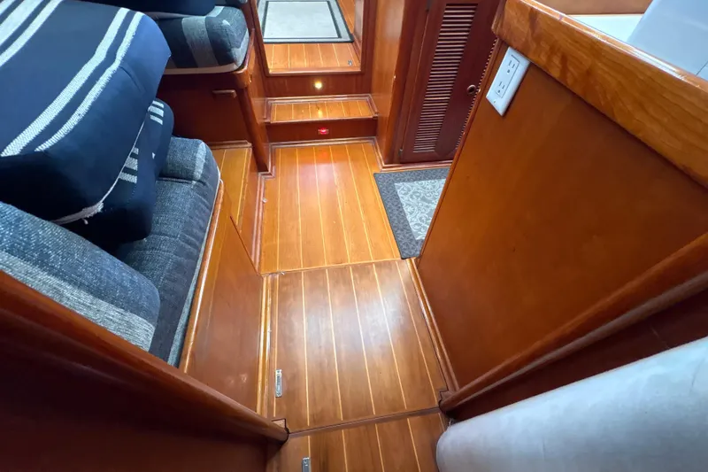 Ganymede Yacht Photos Pics Interior of 2001 North Wind 56 yacht with wooden flooring and striped cushions.