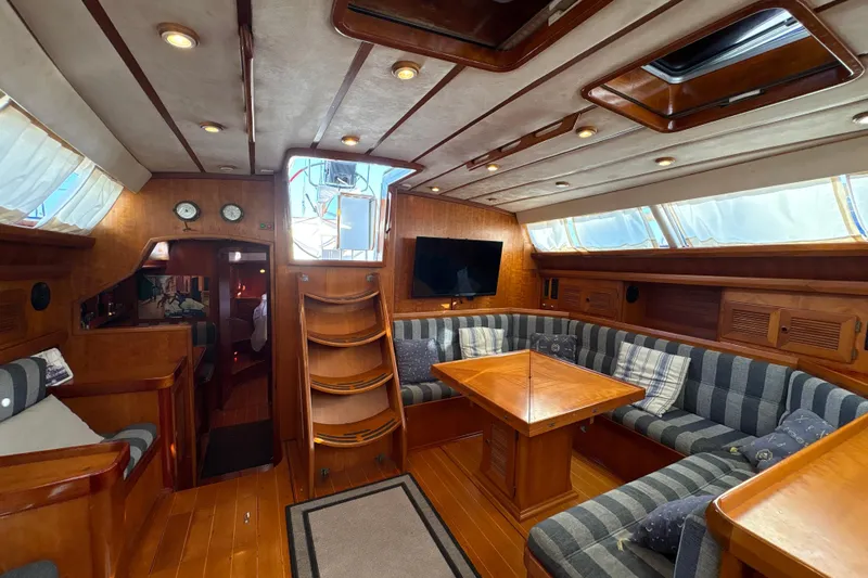 Ganymede Yacht Photos Pics Luxurious 2001 North Wind 56 yacht interior with wood finish and cozy seating area.