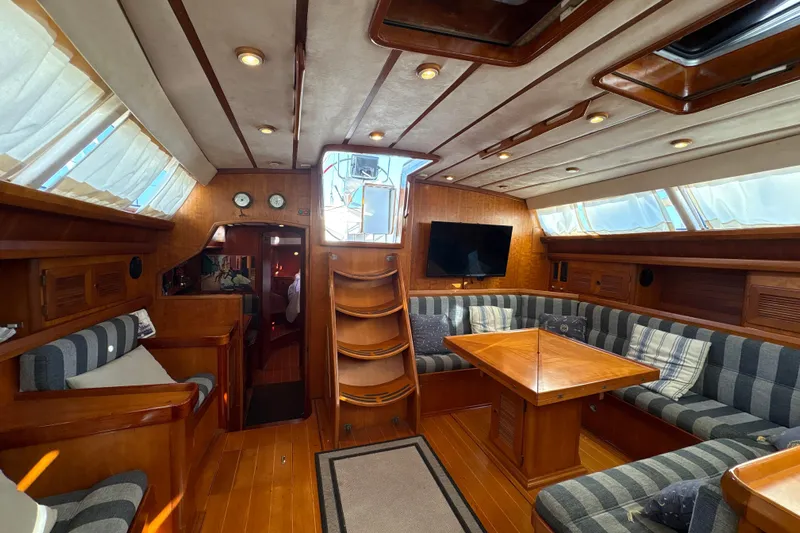Ganymede Yacht Photos Pics Luxurious interior of 2001 North Wind 56 yacht with wood finish and cozy seating area.