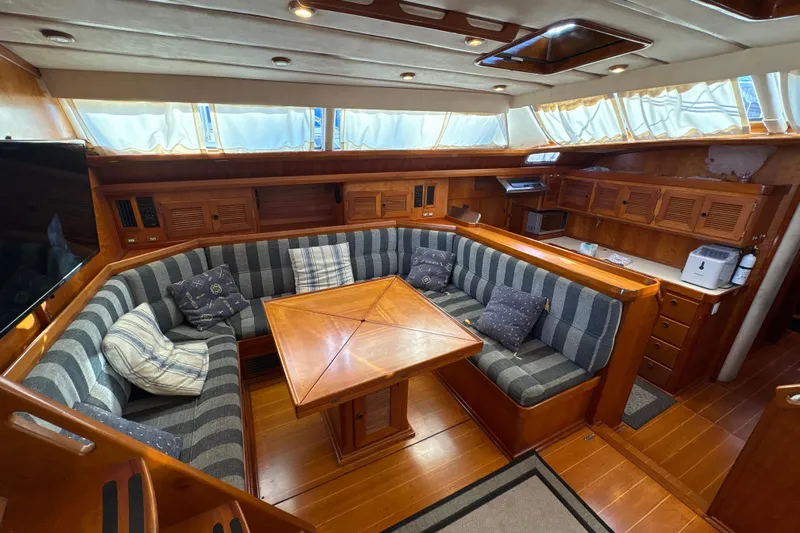 Ganymede Yacht Photos Pics Luxurious interior of 2001 North Wind 56 yacht with cozy seating and wooden finishes.