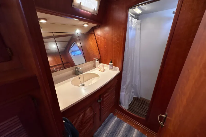 Ganymede Yacht Photos Pics Luxurious bathroom in 2001 North Wind 56 yacht with wooden cabinetry and shower.