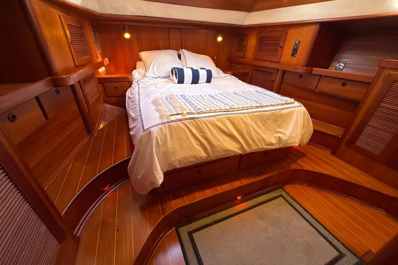 Ganymede Yacht Photos Pics Luxurious wooden cabin interior of 2001 North Wind 56 yacht with cozy bed.