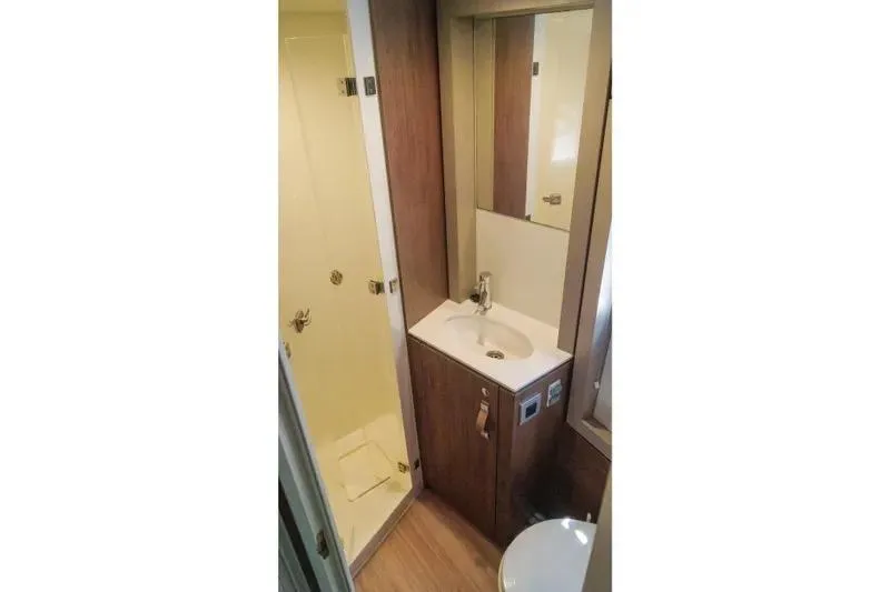  Yacht Photos Pics Compact bathroom in 2023 Bali 4.4 model with shower, sink, and mirror.