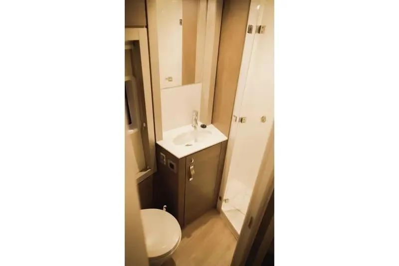  Yacht Photos Pics Compact bathroom in 2023 Bali 4.4 model, featuring sink, toilet, and shower.