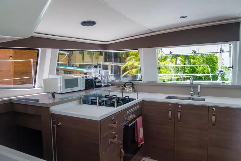  Yacht Photos Pics Modern kitchen interior on 2023 Bali 4.4 yacht with appliances and scenic windows.