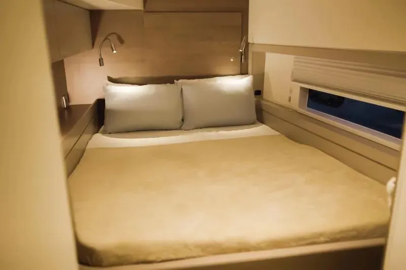  Yacht Photos Pics Cozy bedroom interior in 2023 Bali 4.4 model, featuring a comfortable bed and soft lighting.