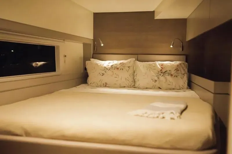  Yacht Photos Pics Luxurious 2023 Bali 4.4 yacht bedroom with cozy bedding and ambient lighting.