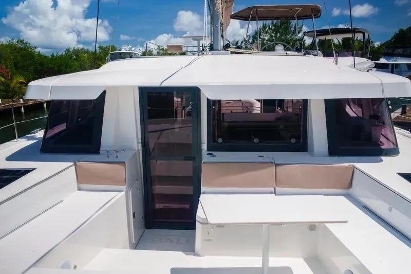  Yacht Photos Pics 2023 Bali 4.4 yacht with spacious deck and modern design, docked under clear skies.