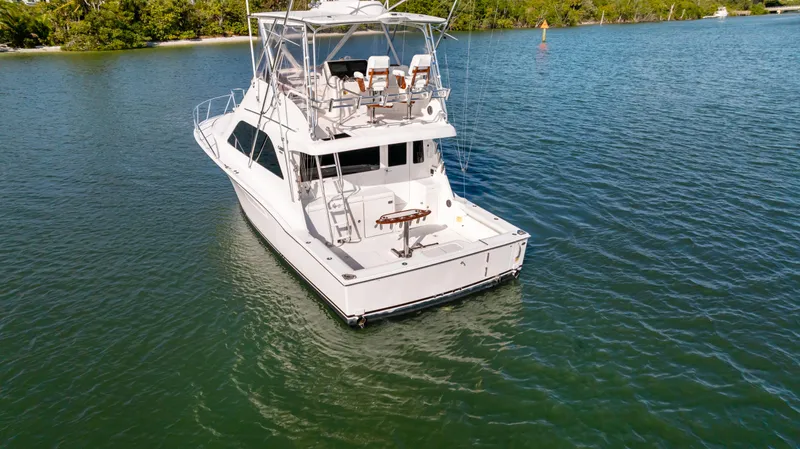 Well Played Yacht Photos Pics 2011 Cabo 40 Flybridge yacht on calm water, rear view.