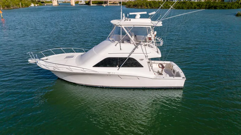 Well Played Yacht Photos Pics 2011 Cabo 40 Flybridge yacht on calm water, side view.