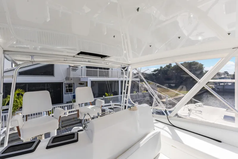 Well Played Yacht Photos Pics 2011 Cabo 40 Flybridge interior with white seating and marina view.
