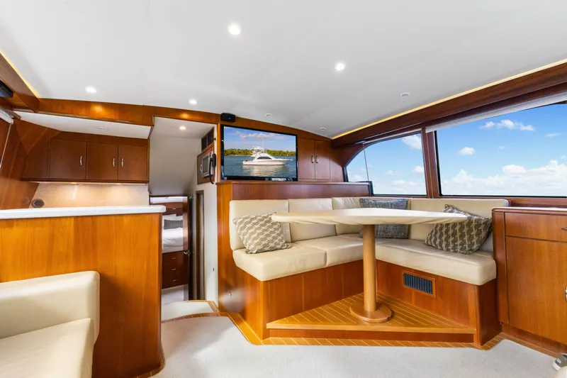 Well Played Yacht Photos Pics Luxurious interior of 2011 Cabo 40 Flybridge yacht with elegant wood finishes and seating area.