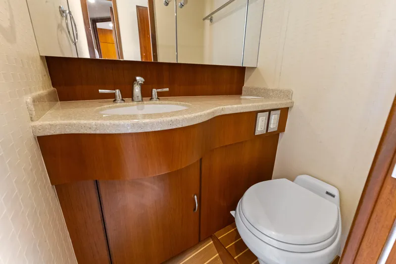 Well Played Yacht Photos Pics Luxurious bathroom in 2011 Cabo 40 Flybridge yacht with modern fixtures and wooden cabinetry.