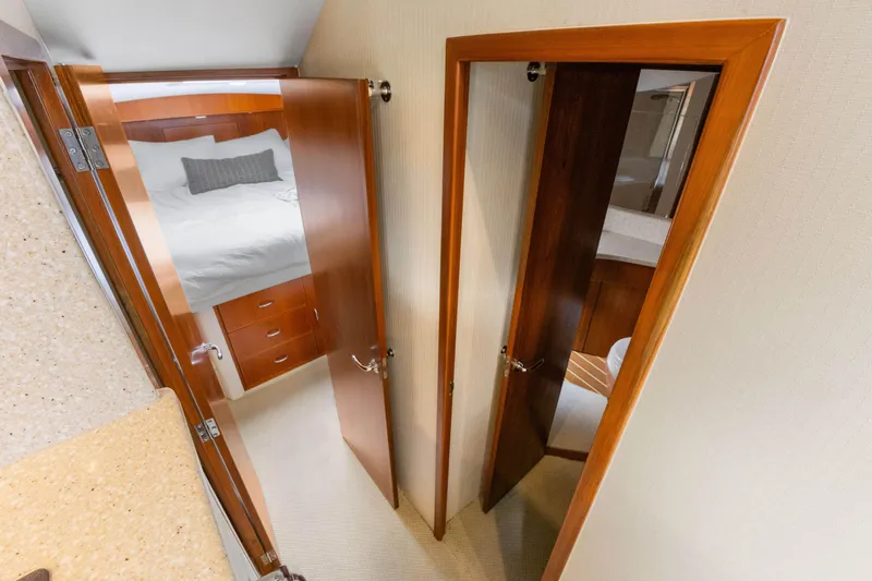 Well Played Yacht Photos Pics Interior of 2011 Cabo 40 Flybridge yacht showing bedroom and bathroom doors.