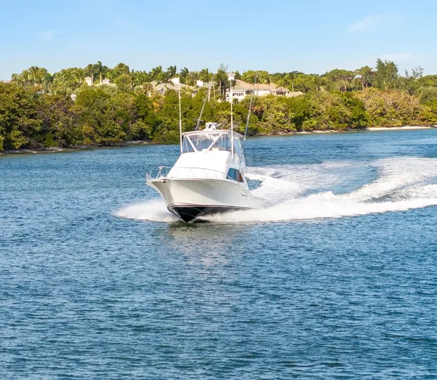 Well Played Yacht Photos Pics 2011 Cabo 40 Flybridge cruising on a scenic waterway.