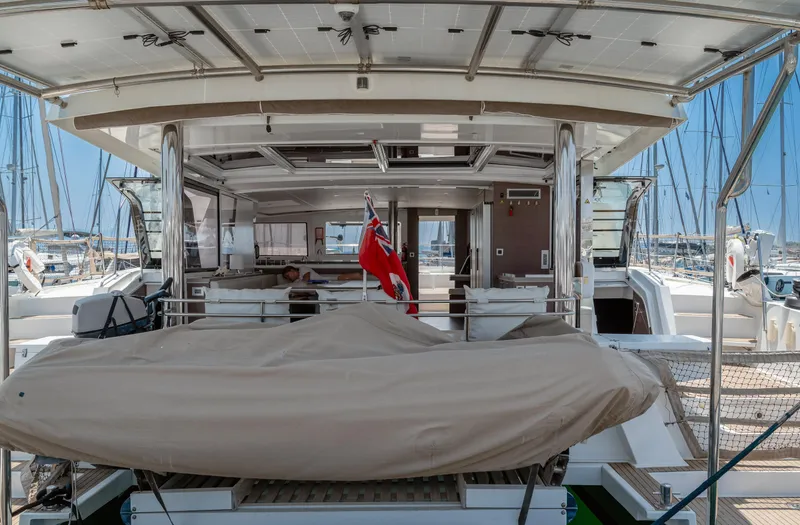 Cinders Yacht Photos Pics 2020 Bali 5.4 yacht with covered dinghy and flag, docked at marina.