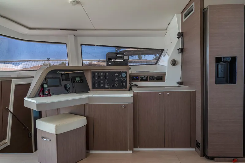 Cinders Yacht Photos Pics Modern interior of 2020 Bali 5.4 yacht with navigation controls and wooden cabinetry.