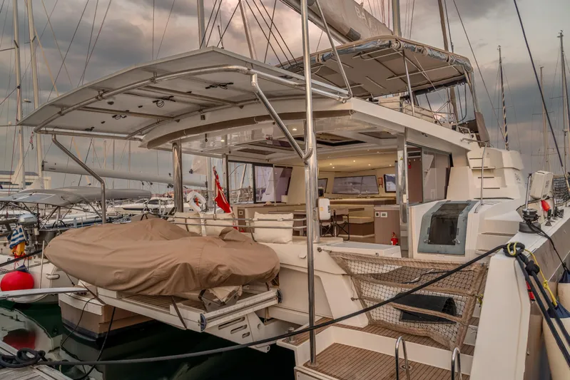 Cinders Yacht Photos Pics Luxurious 2020 Bali 5.4 catamaran docked at marina, showcasing spacious deck and modern design.