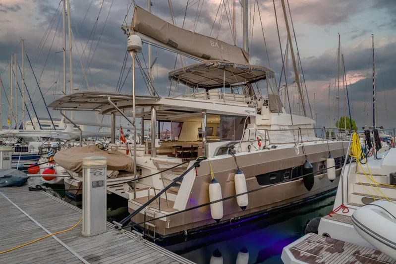 Cinders Yacht Photos Pics Luxury Bali 5.4 catamaran docked at marina, 2020 model, under dramatic sky.