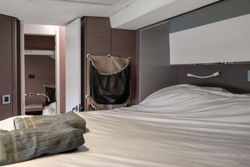 Cinders Yacht Photos Pics Interior of a 2020 Bali 5.4 yacht bedroom with cozy bedding and towels.