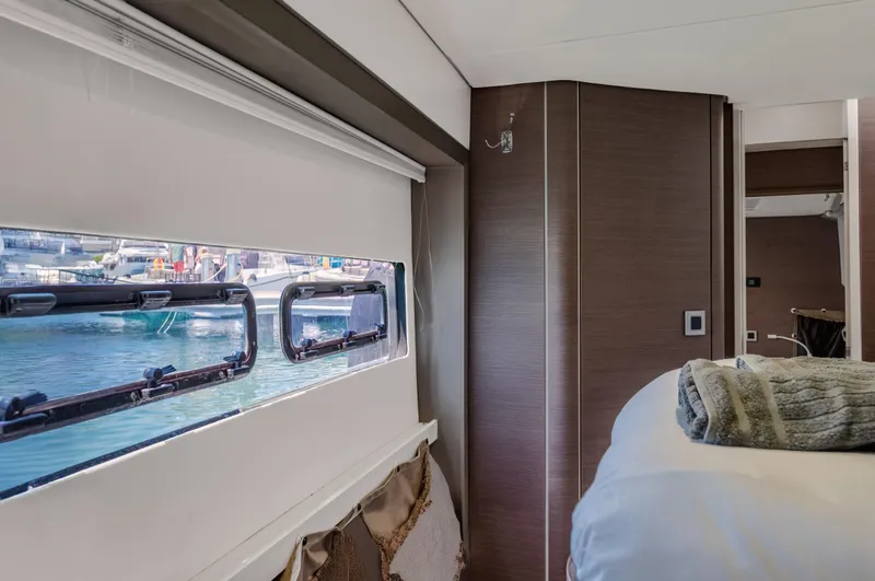 Cinders Yacht Photos Pics Interior of a 2020 Bali 5.4 yacht cabin with window view of marina.