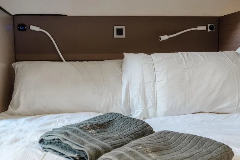 Cinders Yacht Photos Pics Cozy bed with white pillows and folded towels in a Bali 5.4, 2020 model.