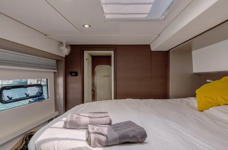 Cinders Yacht Photos Pics Luxurious cabin interior of 2020 Bali 5.4 yacht with bed, towels, and window view.