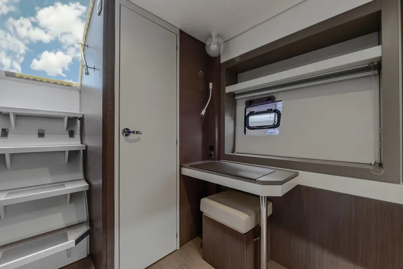 Cinders Yacht Photos Pics Interior of 2020 Bali 5.4 yacht with desk, window, and storage shelves.