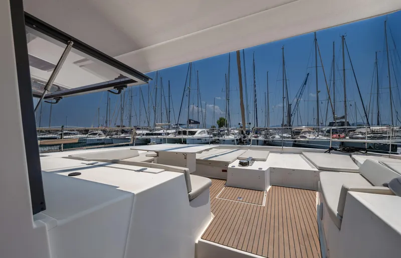 Cinders Yacht Photos Pics Spacious deck of 2020 Bali 5.4 catamaran in marina, surrounded by sailboats.