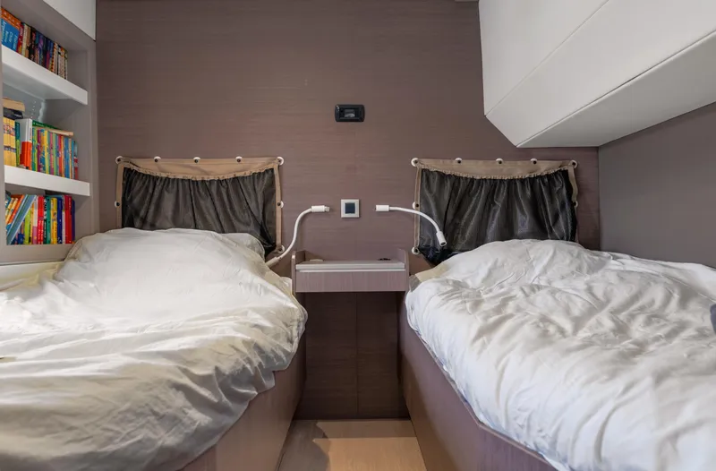 Cinders Yacht Photos Pics Cozy twin beds in a 2020 Bali 5.4 yacht cabin with bookshelves.
