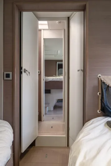 Cinders Yacht Photos Pics Interior view of a 2020 Bali 5.4 yacht cabin hallway with open door.