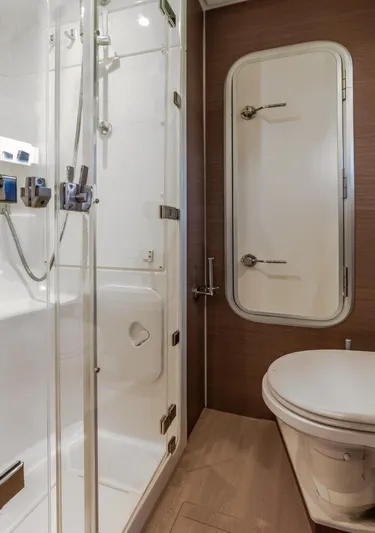 Cinders Yacht Photos Pics Modern bathroom with glass shower and compact toilet in Bali 5.4 yacht, 2020 model.