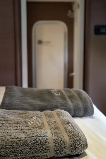 Cinders Yacht Photos Pics Gray towels on a bed inside a Bali 5.4 yacht, 2020 model.