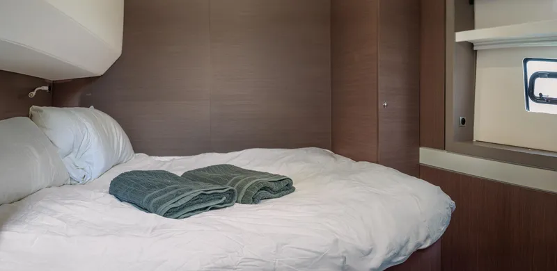 Cinders Yacht Photos Pics Cozy cabin bedroom in 2020 Bali 5.4 yacht with neatly folded towels.