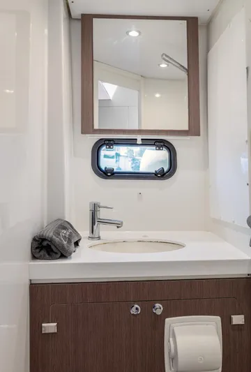 Cinders Yacht Photos Pics Modern bathroom in 2020 Bali 5.4 yacht with mirror, sink, and porthole window.