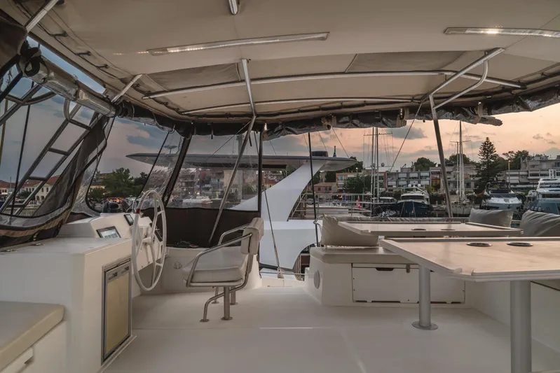 Cinders Yacht Photos Pics Interior view of a 2020 Bali 5.4 yacht at sunset in a marina.