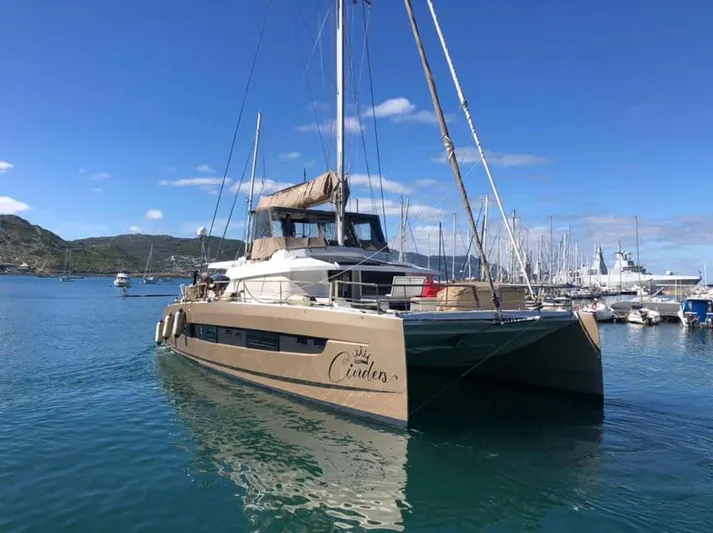 Cinders Yacht Photos Pics 2020 Bali 5.4 catamaran docked in a marina under a clear blue sky.