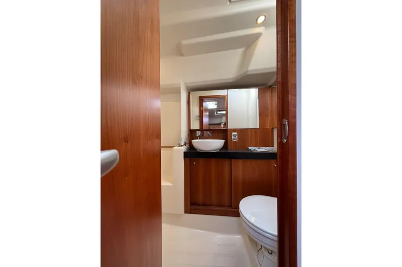  Yacht Photos Pics Luxurious bathroom interior of 2017 Hanse 455 yacht with wooden cabinetry and modern fixtures.