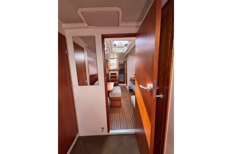  Yacht Photos Pics Interior view of 2017 Hanse 455 yacht, featuring wooden doors and cozy cabin space.