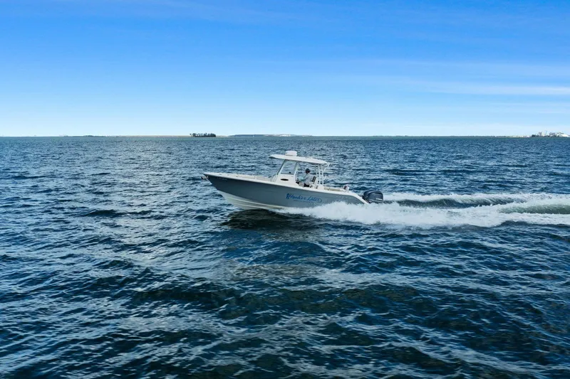  Yacht Photos Pics 2019 Cobia 301 Center Console cruising on open water.