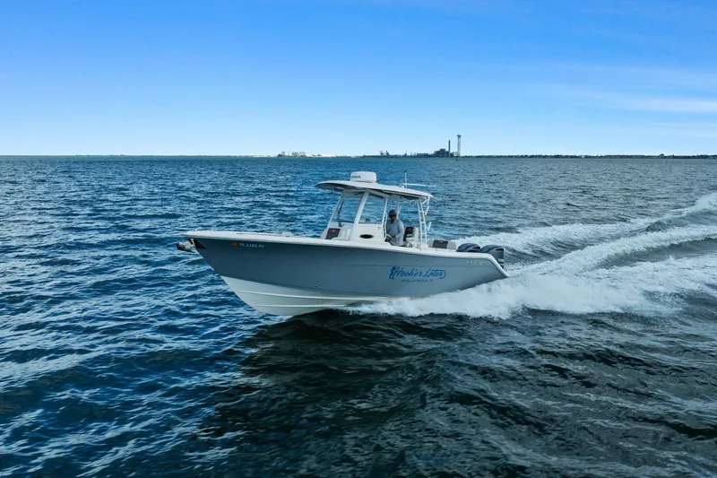  Yacht Photos Pics 2019 Cobia 301 Center Console boat cruising on the sea.