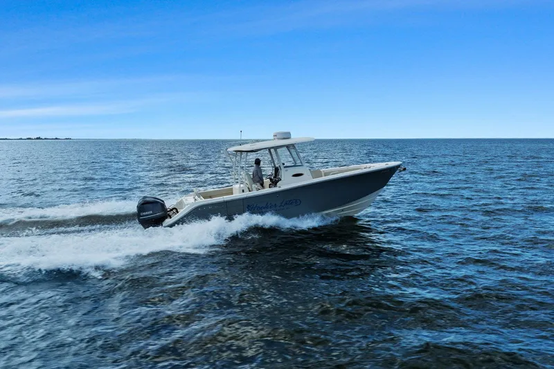  Yacht Photos Pics 2019 Cobia 301 Center Console cruising on open sea.