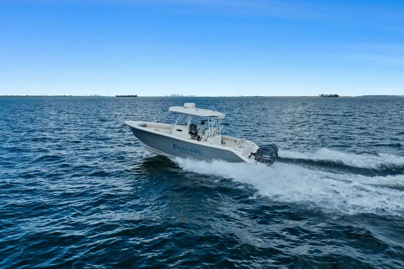  Yacht Photos Pics 2019 Cobia 301 Center Console cruising on open water.