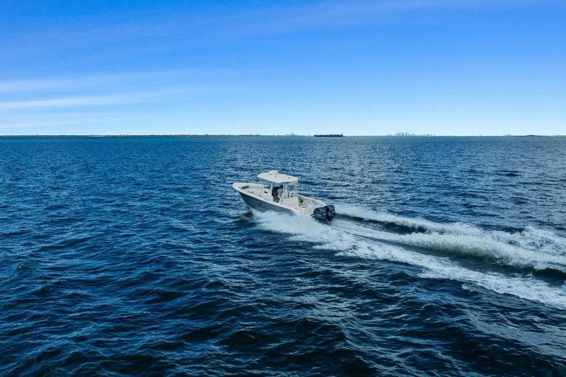  Yacht Photos Pics 2019 Cobia 301 Center Console cruising on open sea.