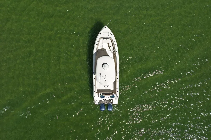  Yacht Photos Pics Aerial view of 2019 Cobia 301 Center Console boat on green water.