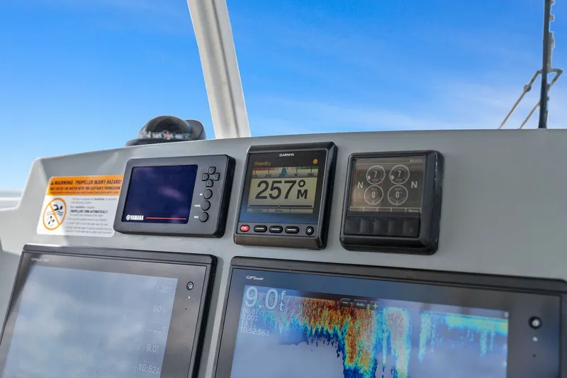  Yacht Photos Pics Dashboard of a 2019 Cobia 301 Center Console boat with navigation instruments.