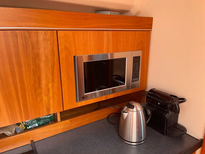  Yacht Photos Pics Modern kitchen in 2017 Hanse 455 yacht with microwave, kettle, and coffee maker.