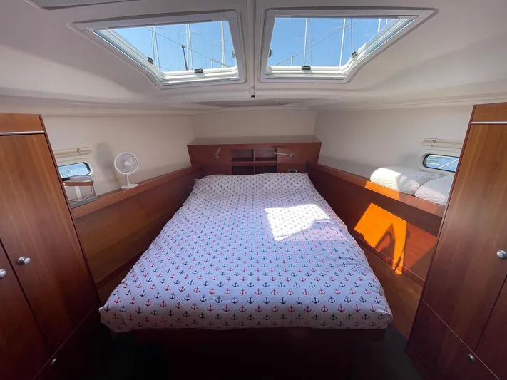  Yacht Photos Pics Cozy cabin interior of 2017 Hanse 455 yacht with skylights and anchor-patterned bedding.