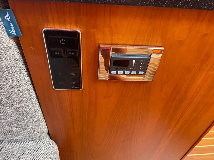  Yacht Photos Pics Control panel on 2017 Hanse 455 yacht with wood finish and digital display.