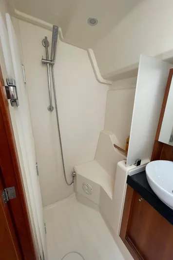  Yacht Photos Pics 2017 Hanse 455 yacht bathroom with shower, sink, and wooden cabinetry.